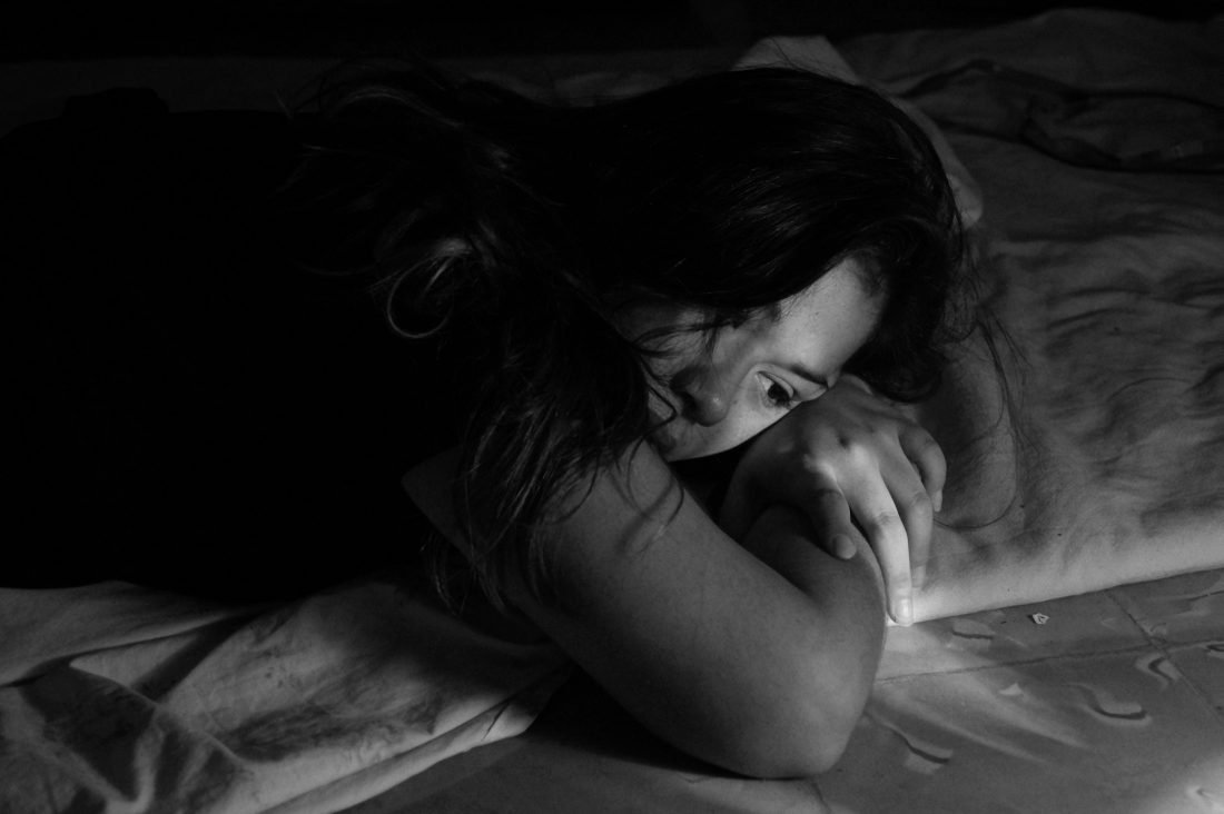 woman on bed black and white - Ask Laura dating advice 