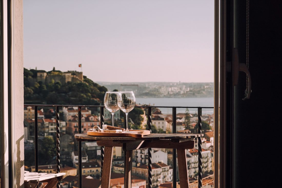 Image of wine glasses by the beach - how much does it cost to be in love - Fave Real